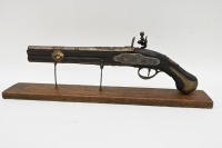 PISTOL: A reproduction flintlock pistol displayed on timber base, pistol 46cm long - 2