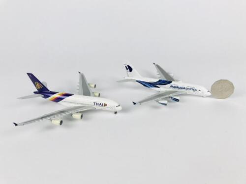 A380: Two models (14cm long): A 1:400 scale Thai International metal Herpa model, and A 1:400 scale Malaysia Airlines metal Herpa model, registration '9M-MNA', both on wheels.