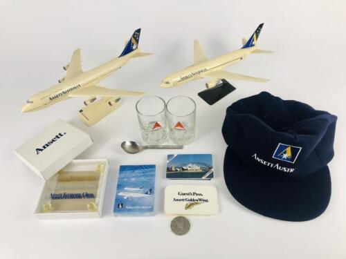 ANSETT: 9 items 1990's: A 1:200 scale (30cm long) Ansett Boeing 747 plastic model on stand, A 1:200 scale Ansett Boeing 777 plastic model on stand, one Ansett Australia wool, viscose cap, one Ansett teaspoon, one Ansett unused deck of playing cards, a se