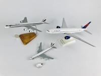 DELTA: 4 models (longest 33cm): A 1:200 scale Boeing 777-200LR resin model on stand, A 1:400 scale Boeing 747-400 metal model on wheels, registration 'N9896', A 1:200 scale McDonnell Douglas DC8 wooden model on stand and one Delta plastic toy plane on pul