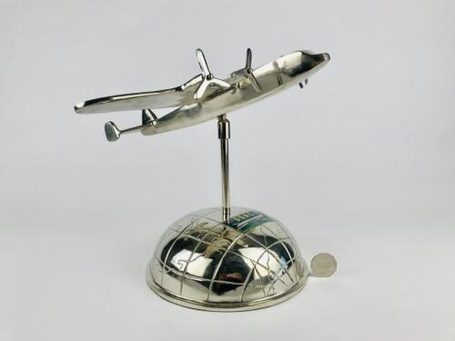 BOAC ART DECO DESK PIECE: A chrome plated articulating plane with spinnable propellors on a chrome half globe.