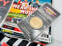 BATHURST: A large group of Bathurst memorabilia including a flag from the 2024 race, a commemorative coin celebrating 50 years of the Bathurst 1000. a 60th anniversary tin sign and a group of race programmes and stickers [Location: Sydney] - 3