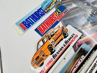 BATHURST: A large group of Bathurst memorabilia including a flag from the 2024 race, a commemorative coin celebrating 50 years of the Bathurst 1000. a 60th anniversary tin sign and a group of race programmes and stickers [Location: Sydney] - 6