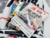 BATHURST: A large group of Bathurst memorabilia including a flag from the 2024 race, a commemorative coin celebrating 50 years of the Bathurst 1000. a 60th anniversary tin sign and a group of race programmes and stickers [Location: Sydney] - 11