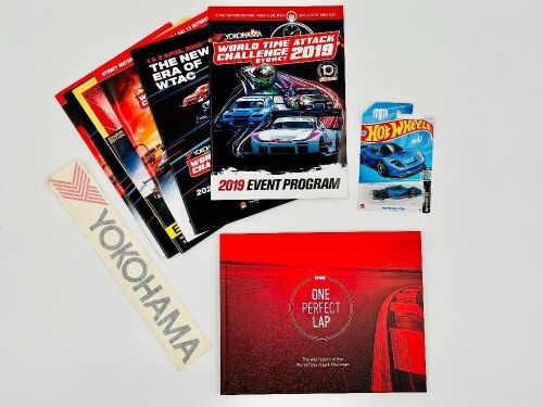 127 · WORLD TIME ATTACK: A hardcover book, 'One Perfect Lap: The Wild History of the World Time Attack Challenge, together with a group of event programmes, a Yokohama sticker and a Hot Wheels model [Location: Sydney]