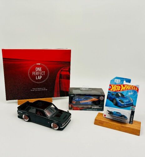 129 · JDM: A hardcover book, 'One Perfect Lap: The Wild History of the World Time Attack Challenge, together with a Jada Toys 1:24 scale Datsun 510, a Jada Toys 1:32 scale Nissan S15 and a 1:64 Hot Wheels model [Location: Sydney]