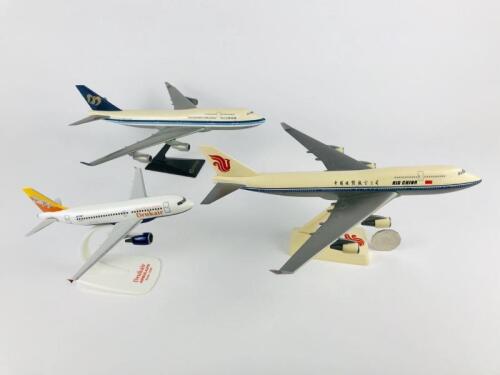 ASIAN CARRIERS: Three models (longest 30cm): A 1:200 scale Mandarin Airlines Boeing 747-400 plastic model, registration 'B-16801', A 1:200 scale Air China747-400 plastic model and A 1:200 scale Drukair Royal Bhutan Airlines Airbus A319 plastic model, regi