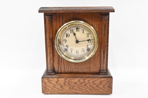CLOCK: A c1920s or 1930s mantle clock in timber case with movement by 'The Sessions Clock Company' (USA), 31cm high