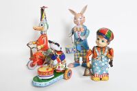 TIN TOY FIGURINES: A group of four tin toy figurines
