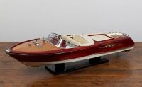 RIVA AQUARAMA: A large Riva Aquarama model speedboat on ebonised timber base, 43cm high (on base), approx. 160cm long