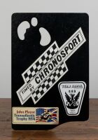 CHRONOSPORT: A circa 1970s timing clip board with affixed American racing stickers and Junghans (Germany) 1/10 Second Stopwatch - 2