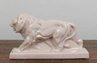 LION: A crackle glaze stylised figure of a prowling lion, 44.5cm long, 13cm wide