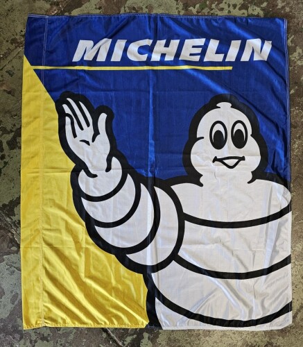 MICHELIN: A cloth Michelin flag featuring Bibendum. Banner with dimensions of 118cm wide, 136cm high overall