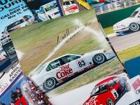 SUPER TOURING: A hardcover book, 'Touring Cars' by John Tipler together with a 3 signed photos by Peter Brock, Geoff Brabham and Jim Richards and a group of race programmes, stickers and posters [Location: Sydney]. - 4