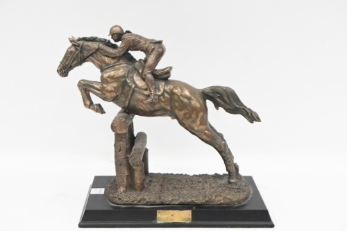 SCULPTURE: A bronze style composite sculpture of jumps jockey, on base, 23cm high