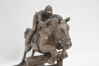 SCULPTURE: A bronze style composite sculpture of jumps jockey, on base, 23cm high - 2