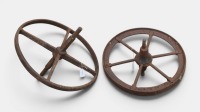WHEELS: Two cast wheels, possibly for cart or wheelbarrow use, one measuring approx 39cm in diameter, the other approx 44cm in diameter