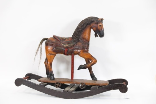 ROCKING HORSE: A large timber horse sculpture on rocking horse style base, 74cm long, 52cm high