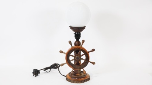 LAMP: A maritime themed lamp, with turning ships wheel to front, on wooden base, 46cm high