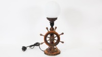 LAMP: A maritime themed lamp, with turning ships wheel to front, on wooden base, 46cm high