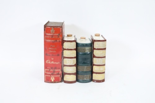 BOOK DECANTERS: Three ceramic book decanters together with one Cadbury tin book biscuit container
