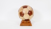 SOCCER BALL: A wooden soccer ball with one opening compartment on pedestal, 27cm high overall