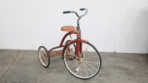 TRIKE: A 1970s children's trike in red and white, measures approximately 89cm high, 100cm long