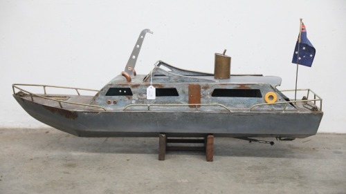 MODEL BOAT: A large metal model patrol style boat on timber base, 102cm long