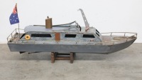 MODEL BOAT: A large metal model patrol style boat on timber base, 102cm long - 2