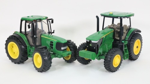 JOHN DEERE: Two large modern John Deere tractor models, largest 33cm long