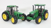 JOHN DEERE: Two large modern John Deere tractor models, largest 33cm long