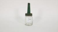 UCL: An Upper Cylinder Lubricant glass bottle with tin top pourer, painted in green