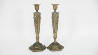 CANDLE HOLDERS: A pair of Art Nouveau style pressed brass candle holders, 29cm high