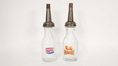 OIL BOTTLES: Two one quart glass oil bottles with later applied Ampol & Golden Fleece stickers, 35cm high