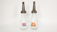 OIL BOTTLES: Two one quart glass oil bottles with later applied Ampol & Golden Fleece stickers, 35cm high