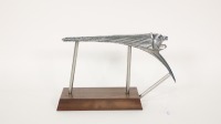 PEUGEOT: A Peugeot 203 roaring lion hood ornament, mounted to a timber base, suitable for desk or shelf display, measures 16cm high, 26cm wide overall - 2