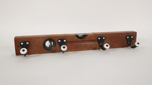 COAT HANGER: A timber and brass Stanley No.104 spirit level repurposed into a coat/key hanger, suitable for man-cave use, measures 45.5cm long