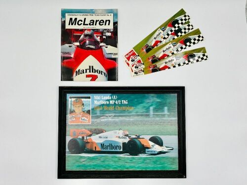 173 · MCLAREN: A framed print of Niki Lauda and his MP4/2 together with four stickers and a copy of 'Kimberley' Grand Prix Team Guide No.5; McLaren' by Bob Constanduros [Location: Sydney]