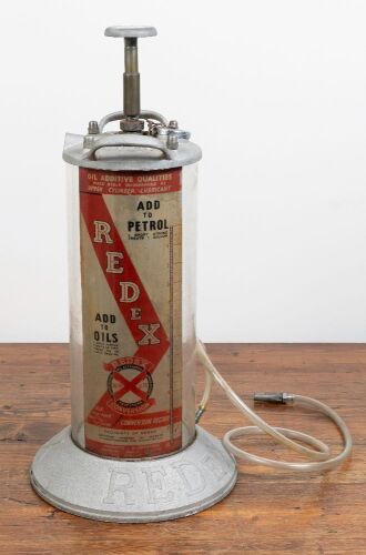 58 · REDEX: A circa 1950s large metal and glass REDeX oil additive unit, with original hose, appears unused, 64cm high