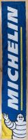 MICHELIN: A large circa 2000 fabric pole banner featuring Bibendum and Michelin, 360cm high, 65cm wide