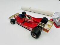 FERRARI: A 1:18 scale Bburago model of the 312 T4 and a 1:43 scale model of the 312T together with a Michele Albereto poster [Location: Sydney] - 3