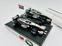 MCLAREN: A 1:24 scale MP4/17 alarm clock by Carrera, together with two McLaren posters [Location: Sydney] - 2