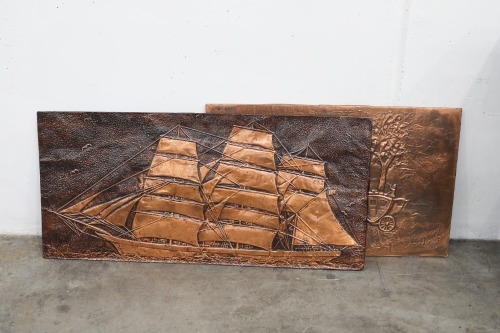 PRESSED COPPER: Two pressed copper wall art pieces, one maritime and other rustic homestead, largest 54cm high, 117cm wide