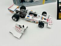 ALAN JONES: A 1:18 scale model by Classic Carlectables of the Lola T332 driven by Alan Jones, complete with certificate of authenticity and and original packaging together with an unwrapped group of photos mounted on card [Location: Sydney] - 3