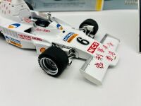 ALAN JONES: A 1:18 scale model by Classic Carlectables of the Lola T332 driven by Alan Jones, complete with certificate of authenticity and and original packaging together with an unwrapped group of photos mounted on card [Location: Sydney] - 4