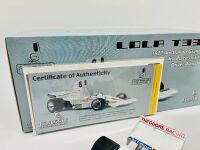 ALAN JONES: A 1:18 scale model by Classic Carlectables of the Lola T332 driven by Alan Jones, complete with certificate of authenticity and and original packaging together with an unwrapped group of photos mounted on card [Location: Sydney] - 8