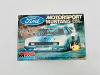 FORD MUSTANG: Two 1:24 scale Mustang model kits including a Motorsport Mustang IMSA Racer by Monogram and a JPS Mustang by Revell [Location: Sydney] - 2