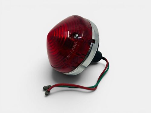 TAIL LAMP: A circular Lucas L692 red tail lamp with chrome bezel