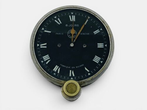 JAEGER CLOCK: A vintage 8-day clock with white markings on black dial, Roman numerals and marked 'Paris' and 'Geneva'