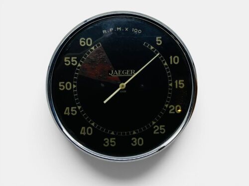 JAEGER TACHOMETER: A large Jaeger Model 12022 6000rpm tachometer with white markings on a black dial and painted redline, 15cm diameter